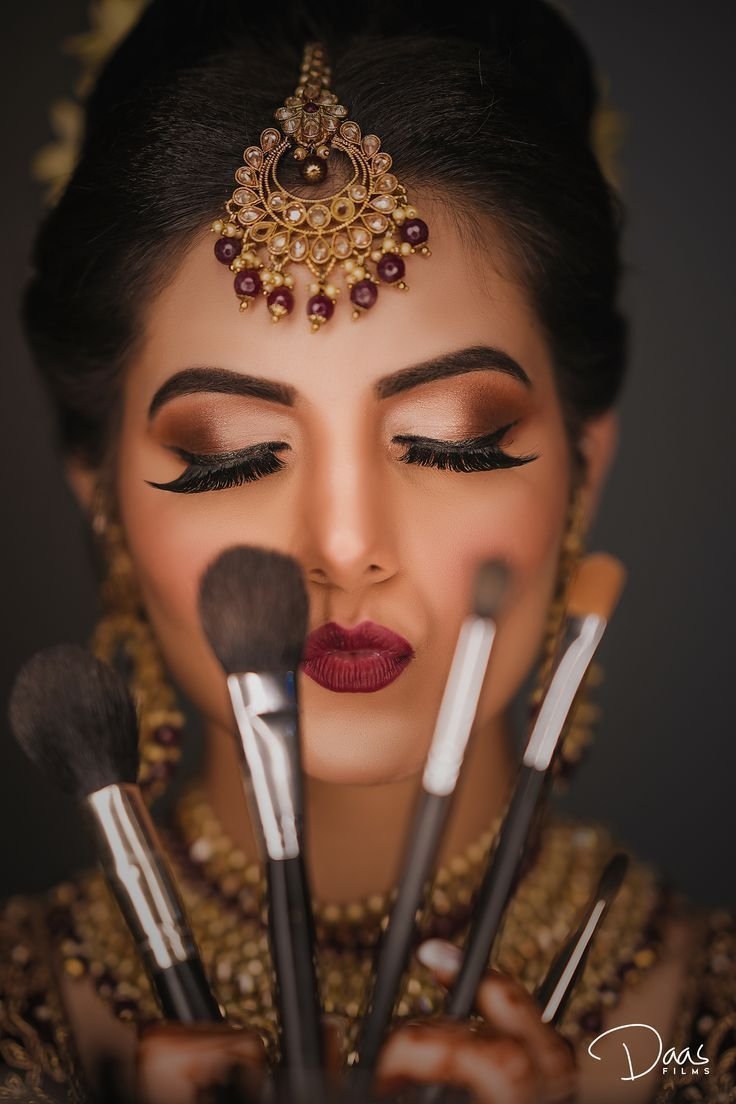 Beauty artist applying makeup with professional brushes