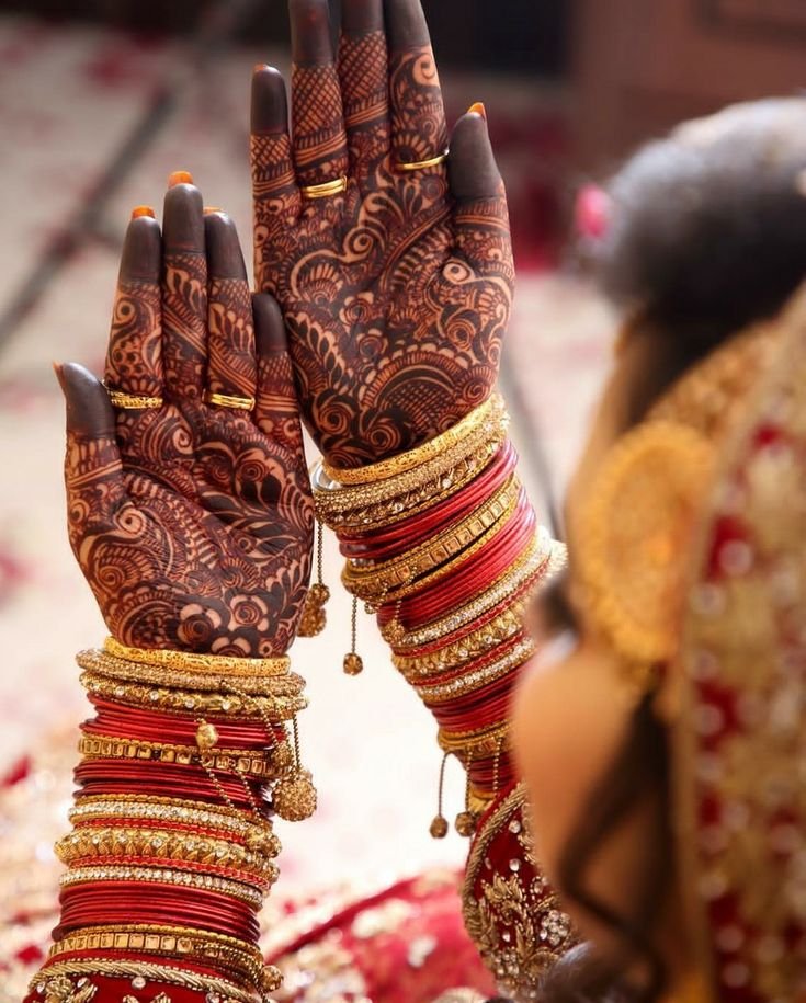 Intricate bridal mehndi designs on decorated hands